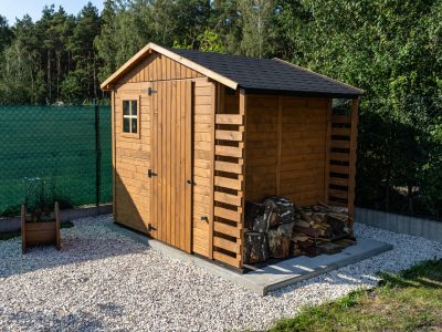 A Wooden Garden Shed Standing On A Concrete Foundation In A Garden