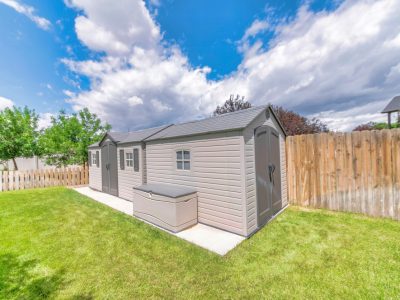 Small Fenced Shed Or Storage With A Green Field